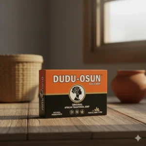 The iconic orange and black box packaging of a fresh bar of Dudu-Osun black soap with the logo clearly visible.