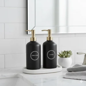A sleek hand soap and lotion dispenser set styled on a modern marble bathroom vanity.